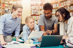 Students using library to prepare for project presentation